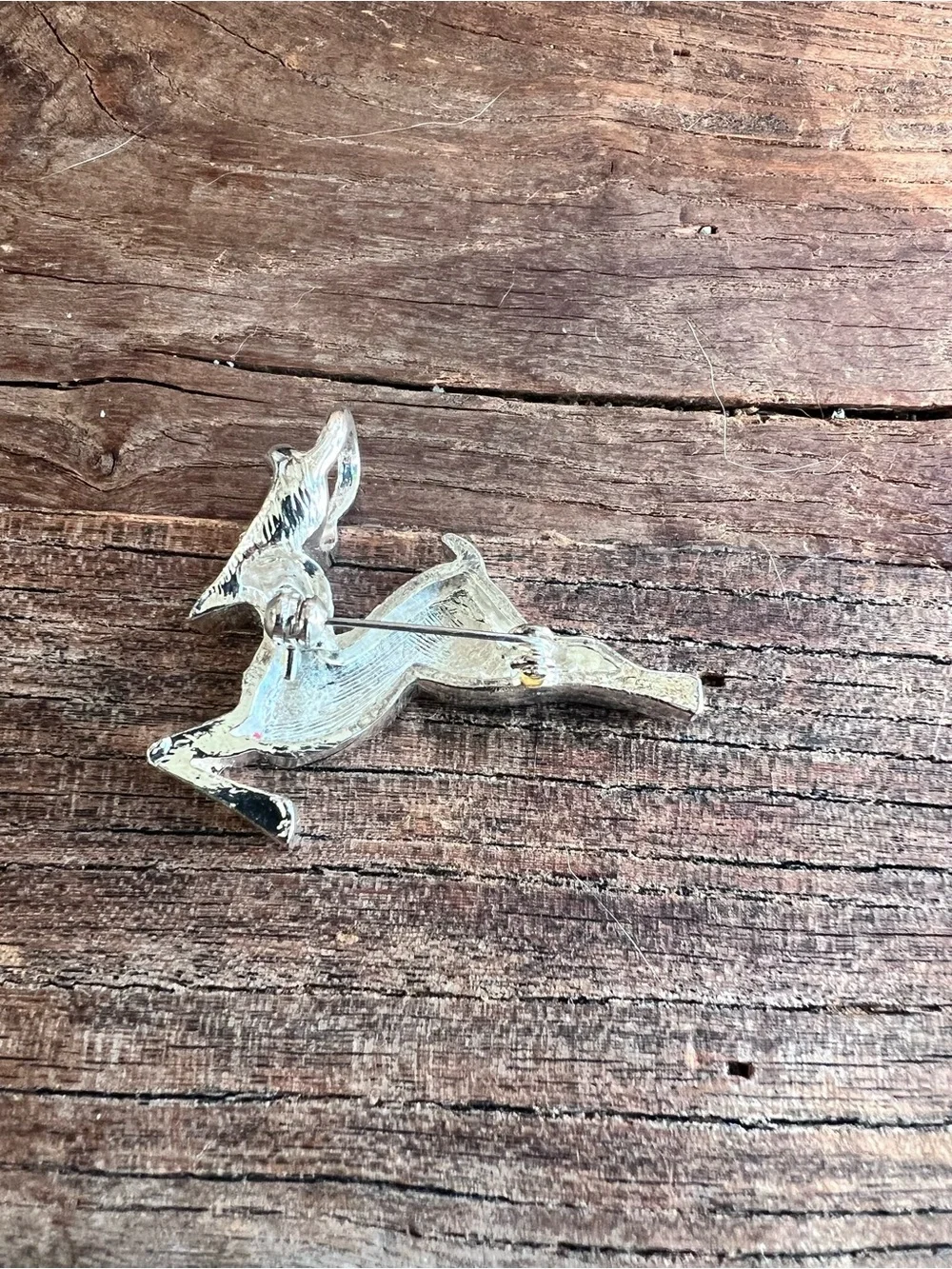 vintage running deer brooch features a stylized, jumping design.  Silver tone